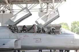 TF-5 cockpit with two pilots and glass displays